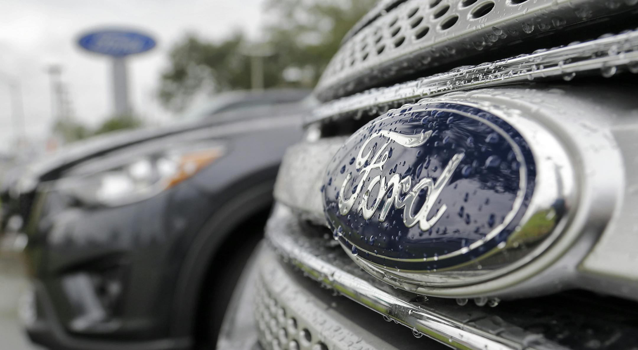 FILE - In this Jan. 12, 2015, file photo, Ford vehicles sit on the lot at a car dealership, in Brandon, Fla. Ford Motor Co. will export vehicles from China to the U.S. for the first time starting in 2019, announced Tuesday, June 20, 2017. Ford will move production of its Ford Focus small car from the U.S. to China, where it already makes the Focus for Chinese buyers. (AP Photo/Chris O'Meara, File)