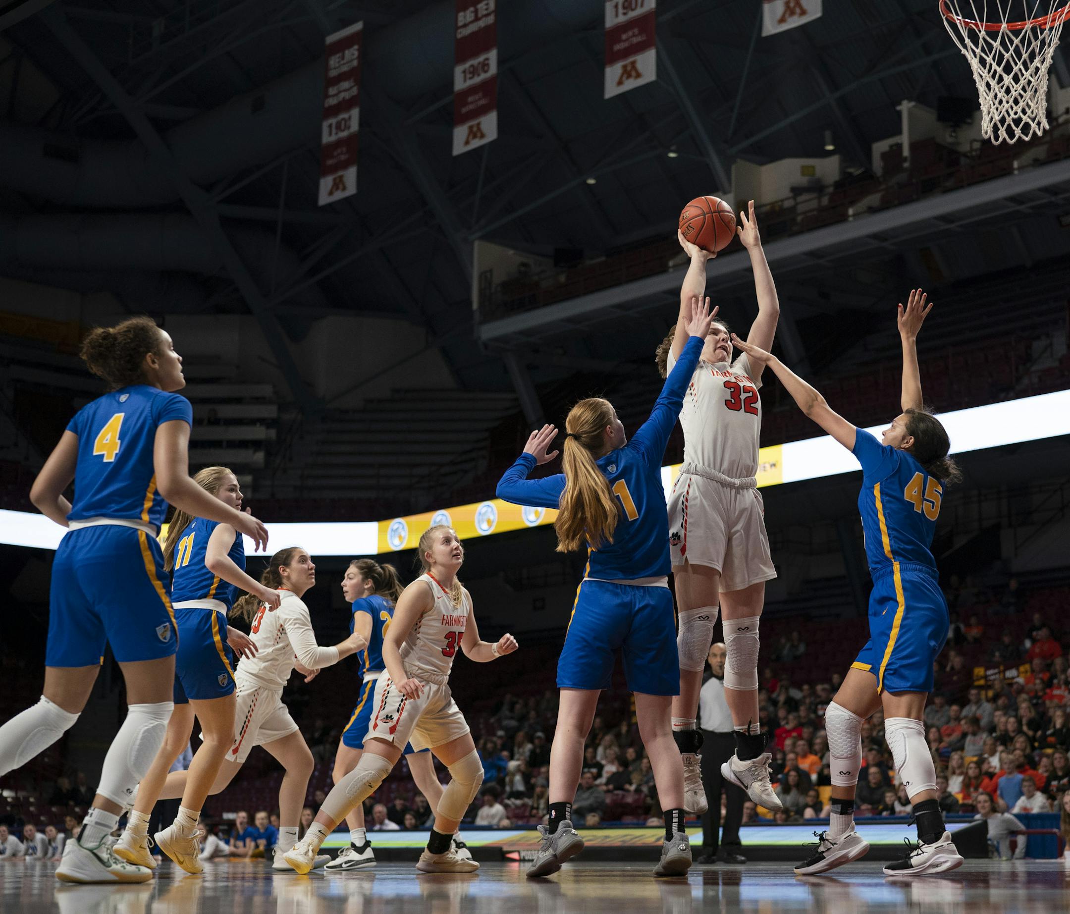 Farmington Tigers center Sophie Hart (32) took a second half shot over St. Michael-Albertville Knights guard Mackenzie Kramer (1) and forward Vanessa Alexander (45). ] JEFF WHEELER • Jeff.Wheeler@startribune.com Farmington held on to defeat St. Michael-Albertville 78-59 in a Minnesota State High School League Class 4A Girls' Basketball Tournament semi-final game Thursday night, March 12, 2020 at Williams Arena in Minneapolis.
