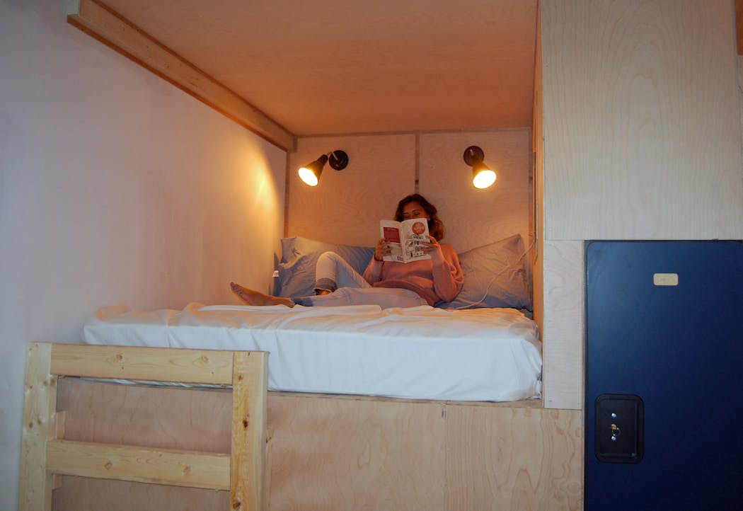 Hostel du Nord assistant manager Marguerite Bennett sits in a double-bunk bed at the hostel.