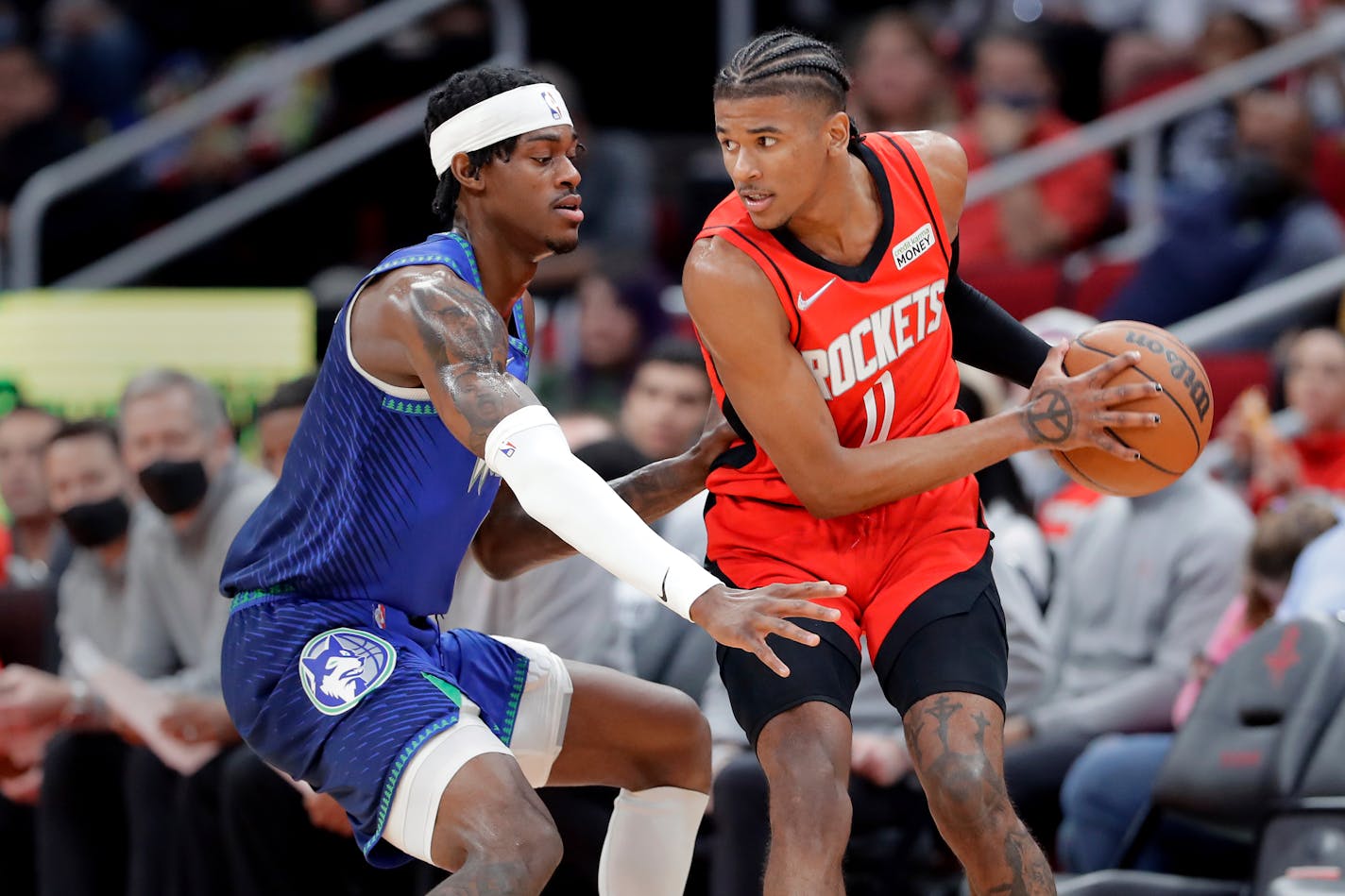 Rockets guard Jalen Green looks to pass the ball under pressure from Timberwolves forward Jarred Vanderbilt on Sunday night in Houston.