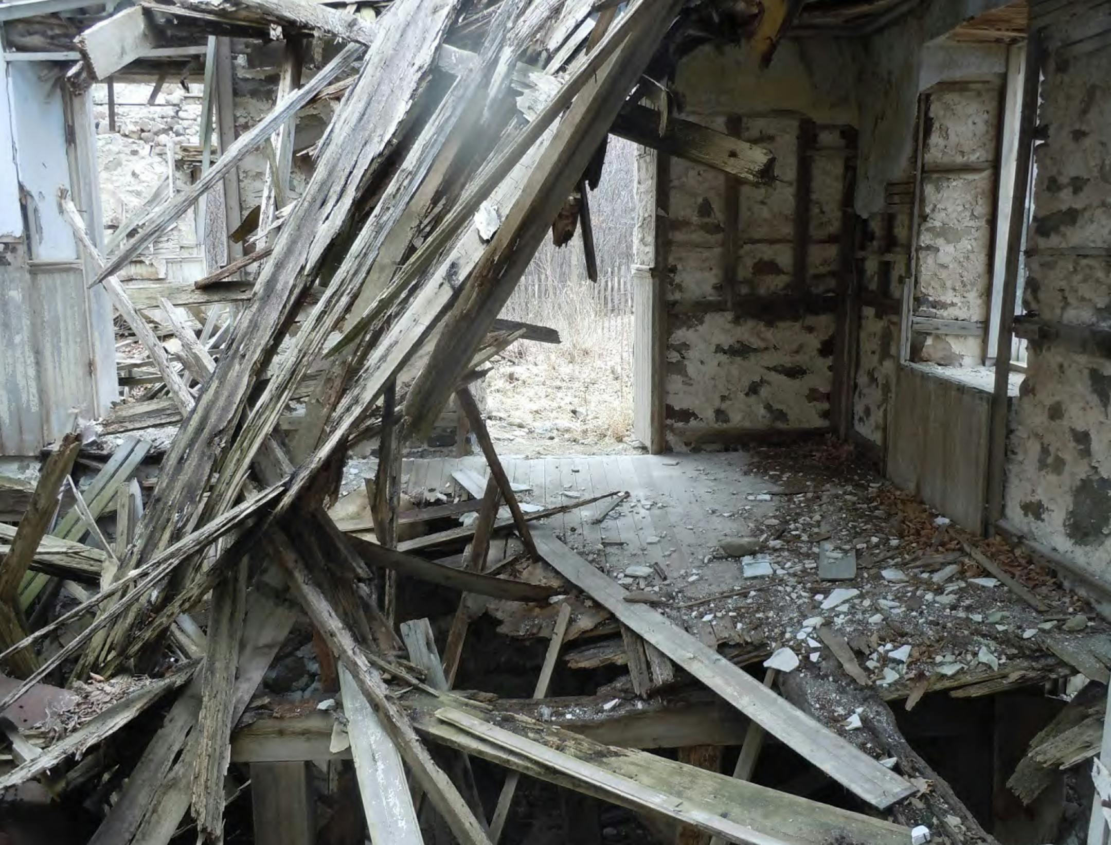 Interior of upright portion of Schmid Farmhouse Ruin, showing intact portion of its first floor, looking south. Photo by Three Rivers Park District.
