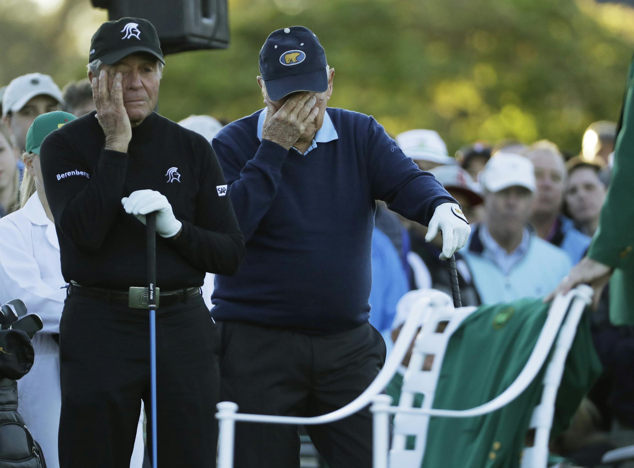 Jack Nicklaus and Gary Player wipe tears from their eyes as a chair is draped with a green jacket to honor Arnold Palmer before the start of the first round of the Masters golf tournament Thursday, April 6, 2017, in Augusta, Ga. (AP Photo/David J. Phillip)