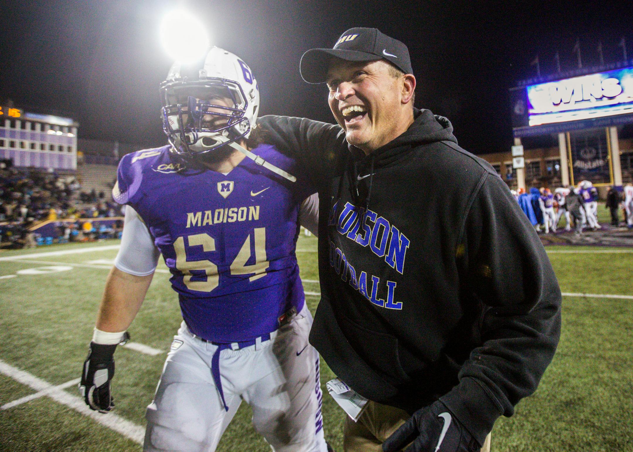 FILE - In this Dec. 9, 2016 file photo, James Madison head coach Mike Houston, right, celebrates with offensive lineman Matt Frank after a game against Sam Houston State.
