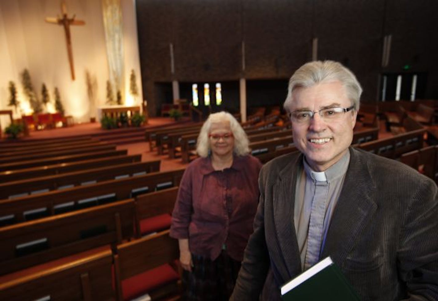 The Rev. Mike Tegeder, pastor at St. Edward's Catholic Church in Bloomington, was contacted by an archdiocesan official after Heidi Busse, who is in charge of adult faith education at the parish, preached the homily at a Jan. 23 mass. At left is the church's director of worship, Lonne Murphy.