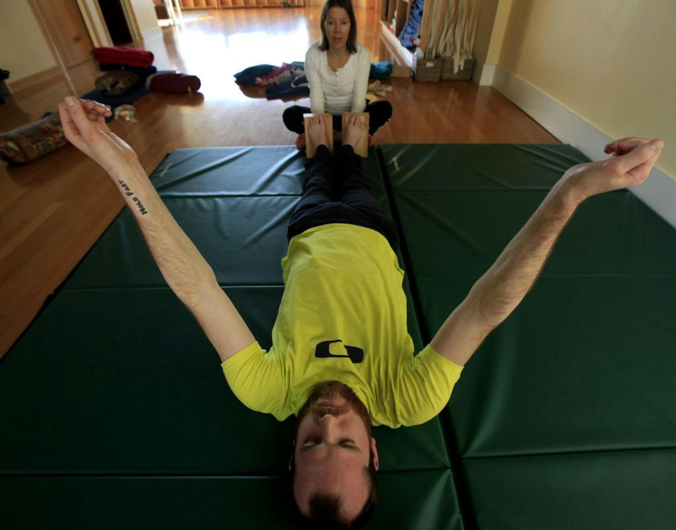 Thomas Cloyd does adaptive yoga at Mind Body Solutions with Yoga instructor Mary Pat Fitzpatrick ( in white) in Minnetonka, MN on January 3, 2013.