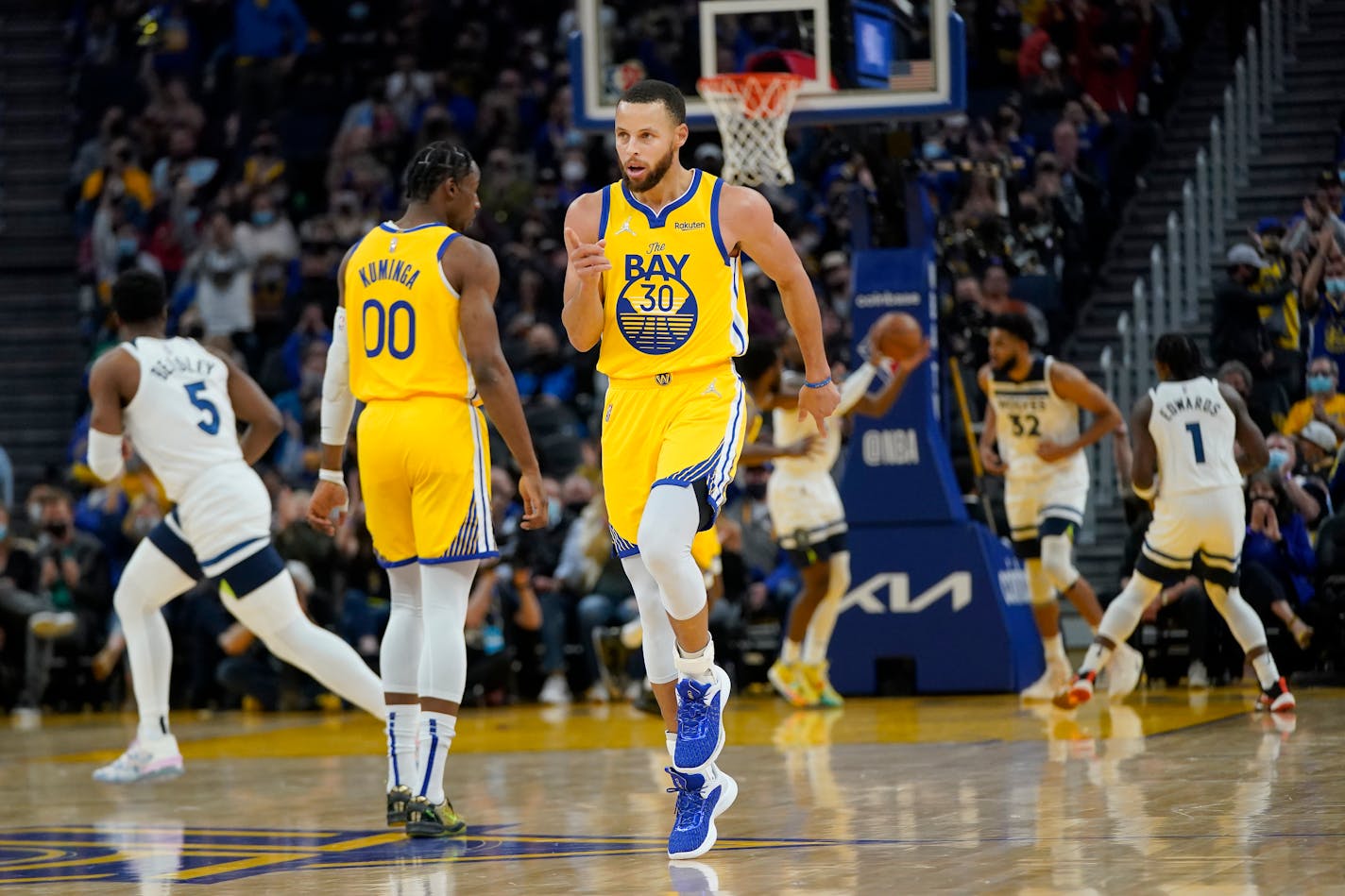 Golden State guard Stephen Curry reacts after shooting a 3-point basket against the Timberwolves on Thursday night.