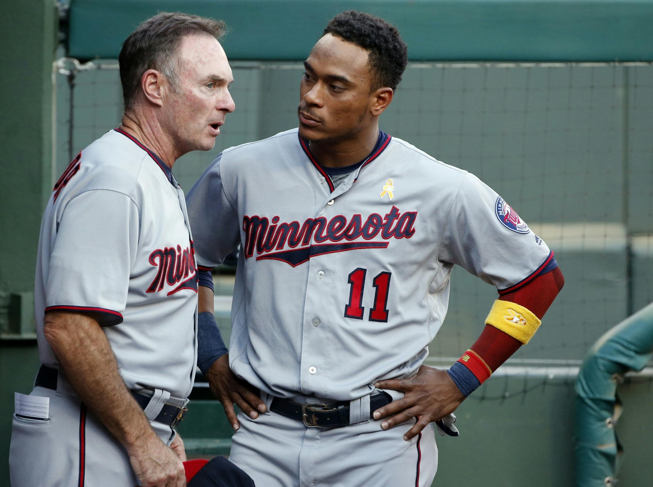 Minnesota Twins manager Paul Molitor (4) talks to Jorge Polanco (11) prior to playing the Texas Rangers during a baseball game Saturday, Sept. 1, 2018, in Arlington, Texas.