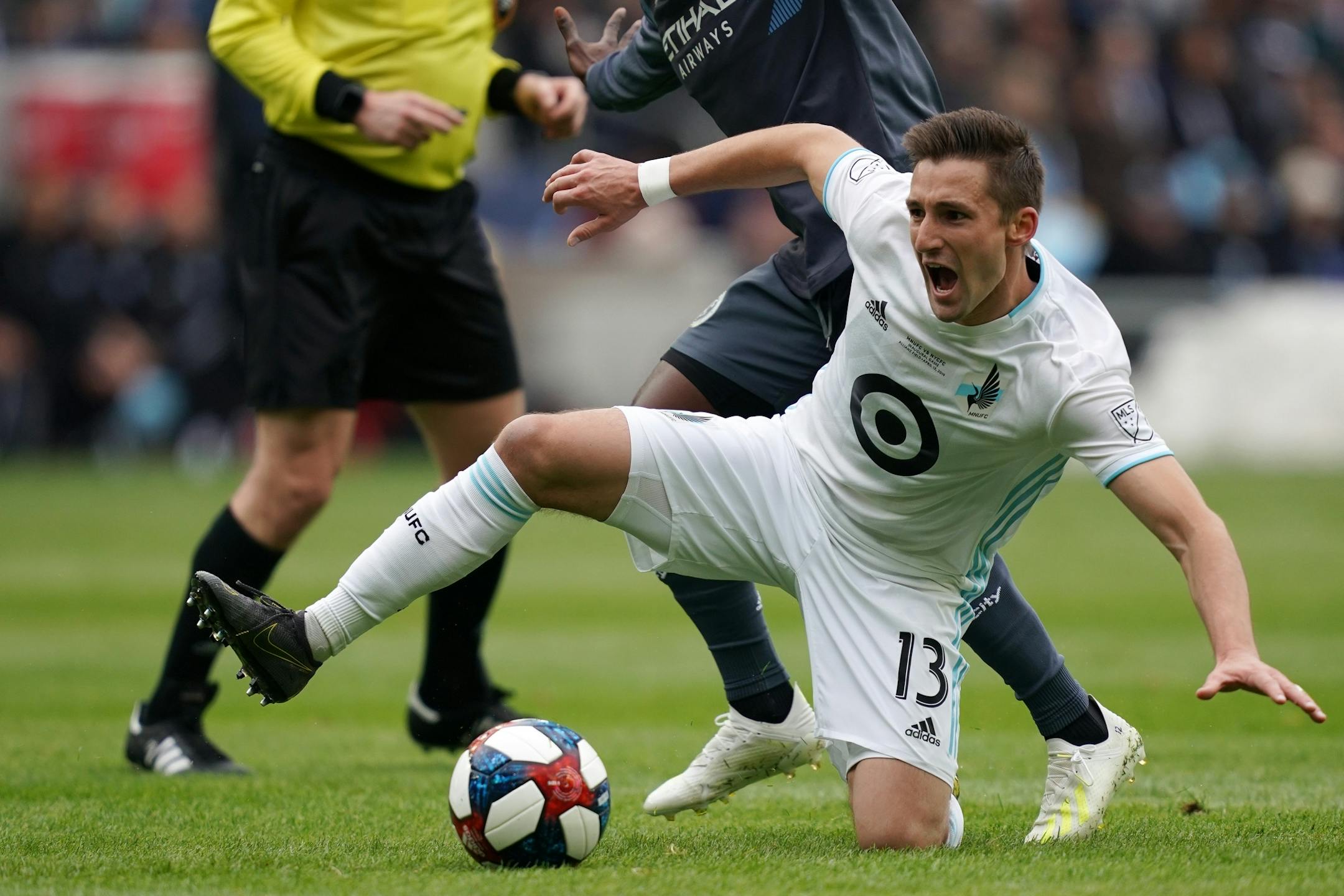Minnesota United midfielder Ethan Finlay (13) went down as he got tangled up with New York City midfielder Ebenezer Ofori (12) in the first half.