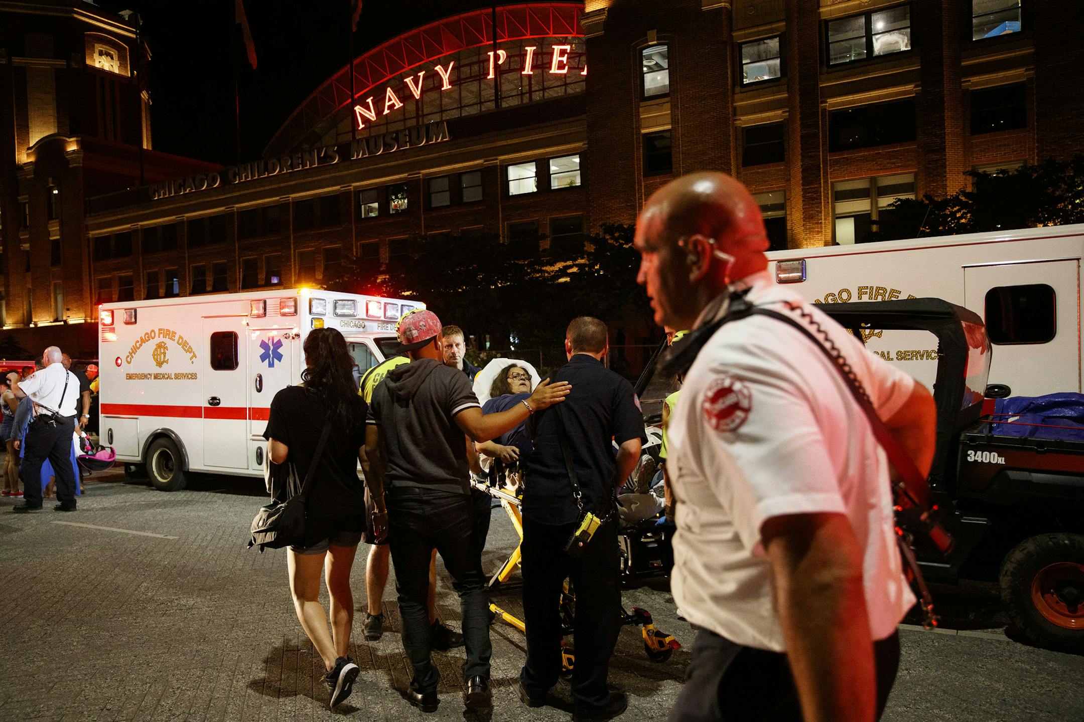 Paramedics transport a person from the scene where three people were stabbed during an altercation outside Navy Pier after a Fourth of July fireworks show Thursday July 4, 2019, in Chicago. (Armando L. Sanchez/Chicago Tribune/TNS)