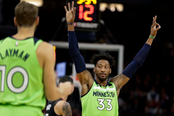Timberwolves forward Robert Covington celebrates a three-point basket with Jake Layman during a game against the Rockets earlier this month.