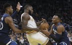 Minnesota Timberwolves guard Josh Okogie, right, takes the ball from Golden State Warriors forward Eric Paschall, center, during the second half of an