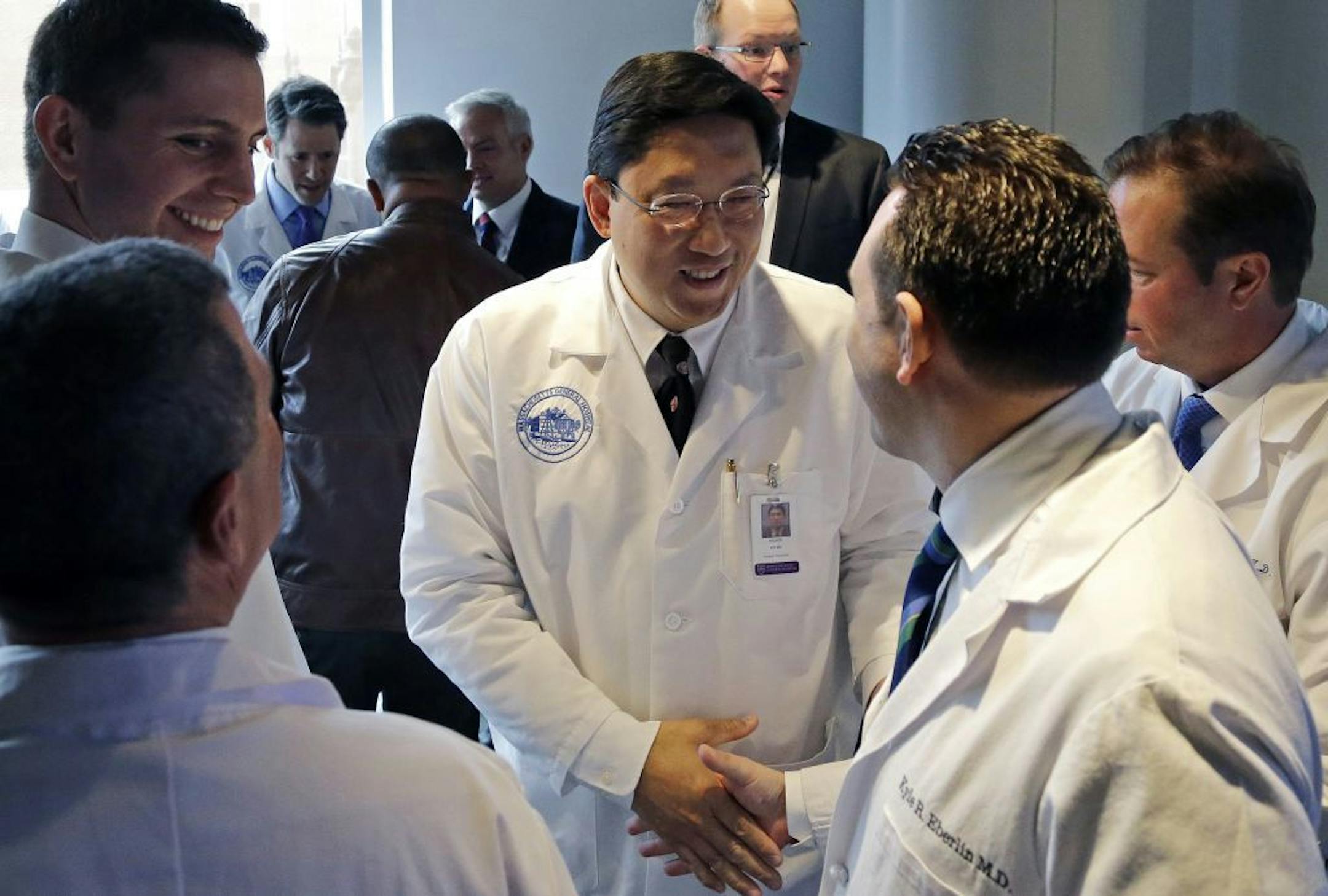 Dr. Dicken Ko, director of Massachusetts General Hospital's urology program, shakes hands with surgical team members after a news conference at the hospital, Monday, May 16, 2016, in Boston to announce the first penis transplant in the United States. Cancer patient Thomas Manning, of Halifax, Mass., received a transplanted penis in a 15-hour procedure last week. The organ was transplanted from a deceased donor.