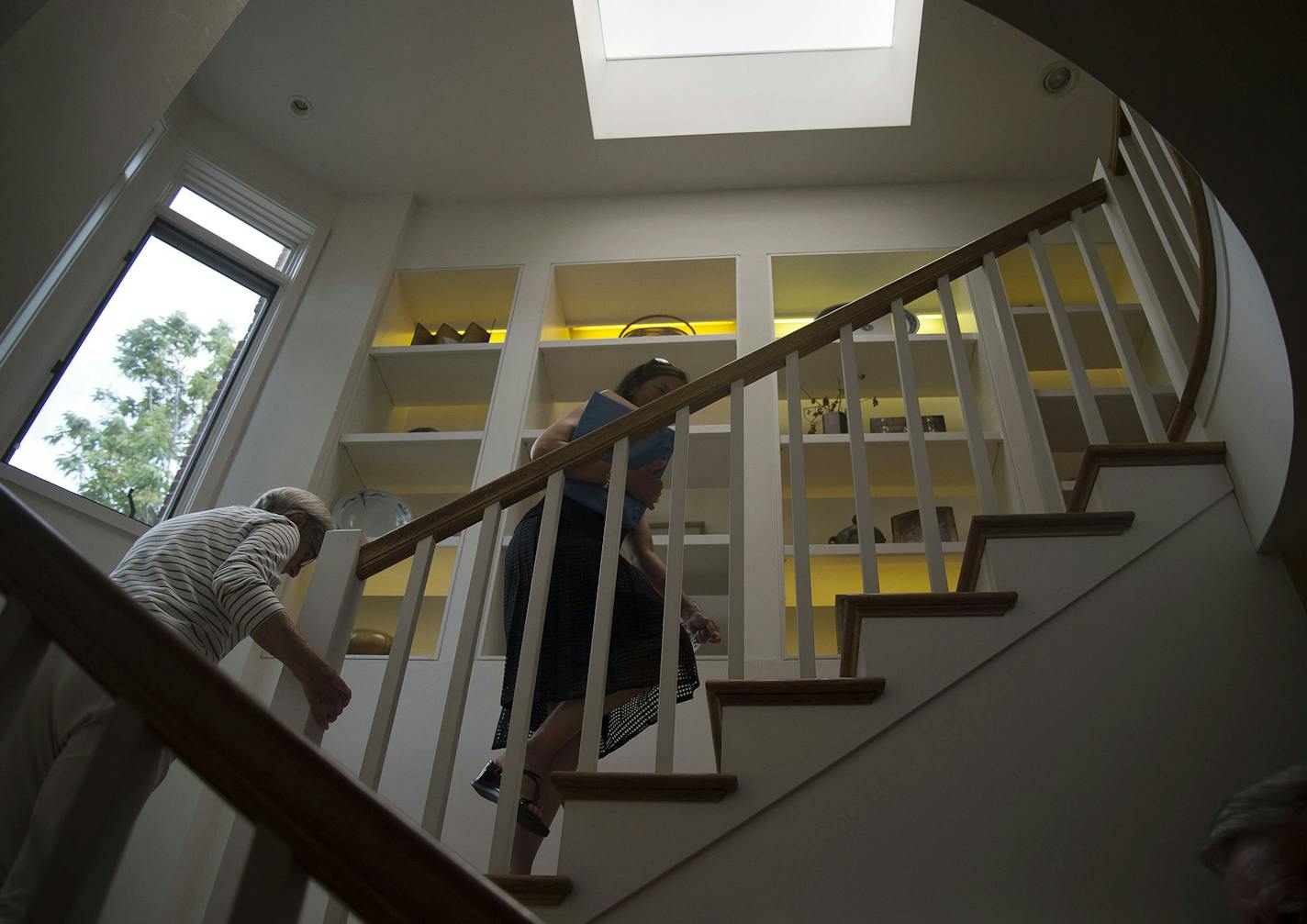 From left, Scotty Gillette and Realtor Betsy Lucas walked upstairs in the Gillette's townhouse in Minneapolis on July 10. The Gillettes are selling their townhouse and will move to a senior living facility in downtown Minneapolis. Houses sold at a record pace during June in the Twin Cities metro, according to a monthly report from the Minneapolis Area Association of Realtors.