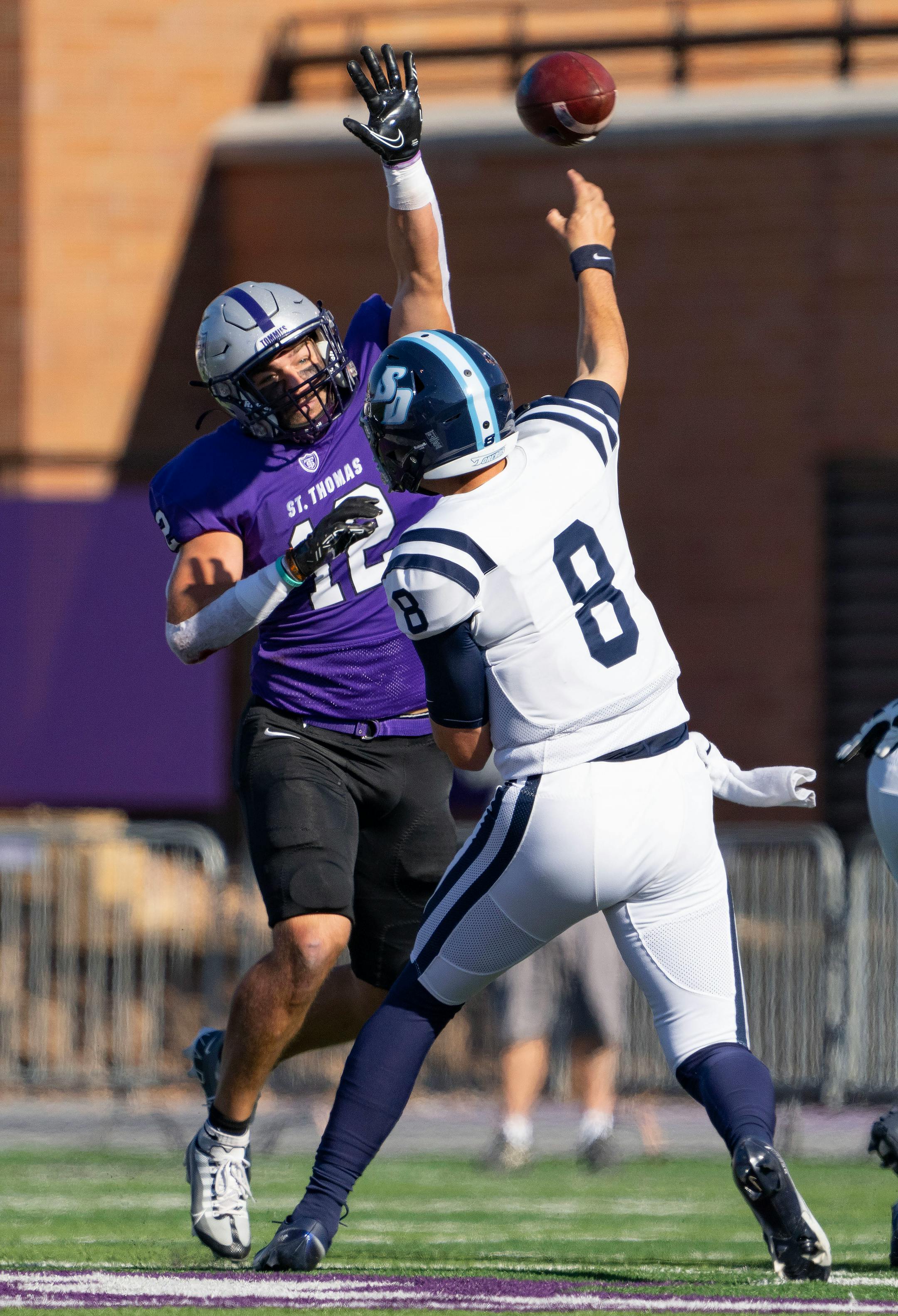 St. Thomas linebacker Trent Meyer (12) tips a pass attempt by San Diego Toreros quarterback Judd Erickson (8) in the first quarter.