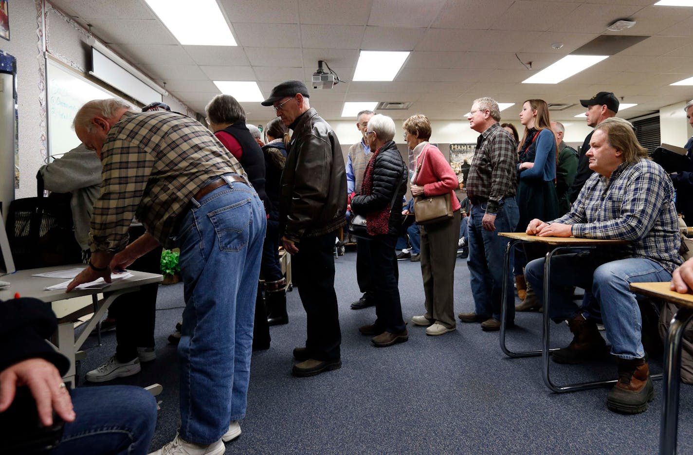 Republicans register in their precinct as they caucus at Bloomington Jefferson High School Tuesday, March 1, 2016, in Bloomington, Minn. Voters from Vermont to Colorado, Alaska to American Samoa and a host of states in between took to polling places and caucus sites Tuesday, on the busiest day of the 2016 primaries. (AP Photo/Jim Mone)