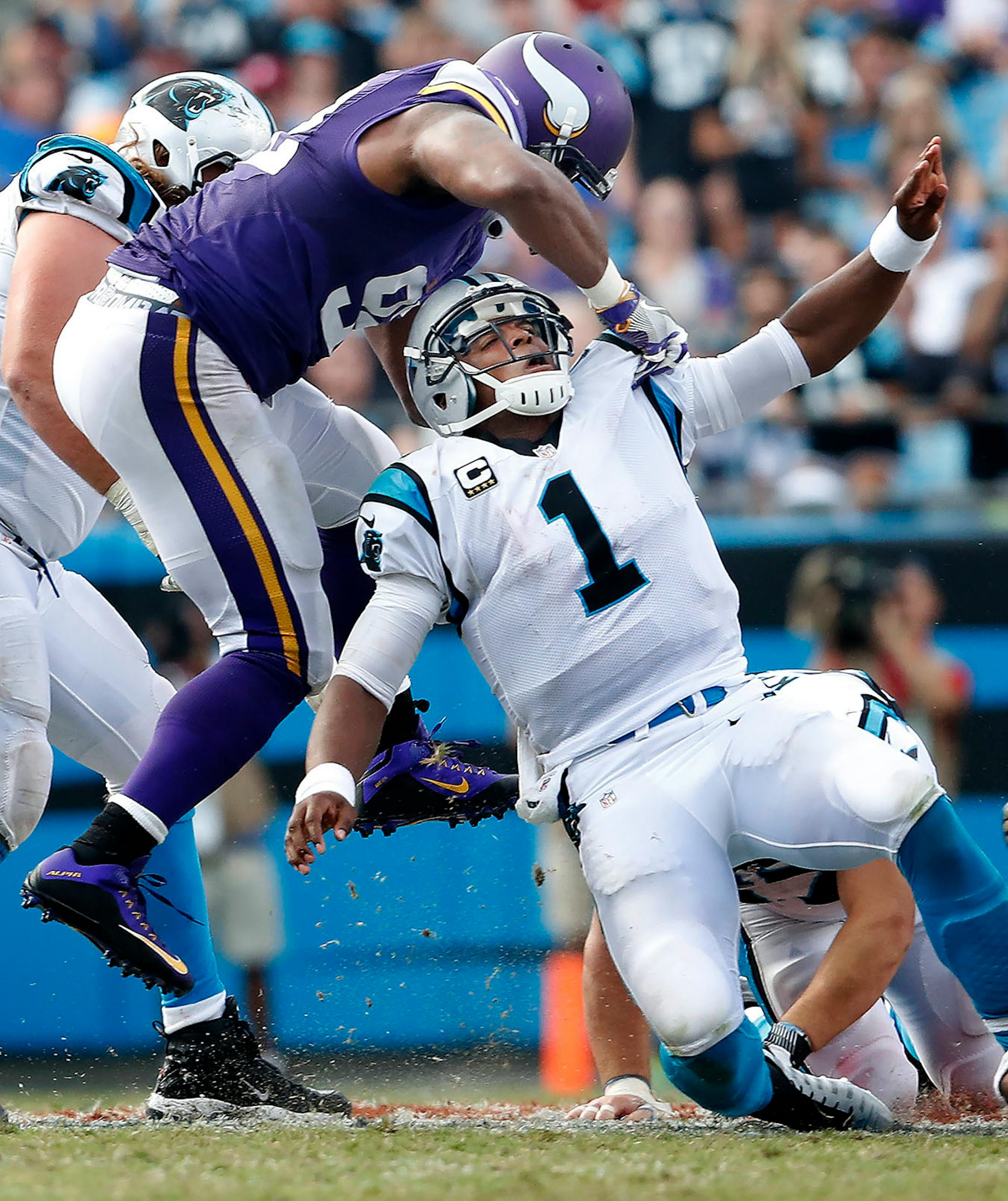 Cam Newton (1) was pressured by Danielle Hunter (99) after throwing a pass in the fourth quarter.