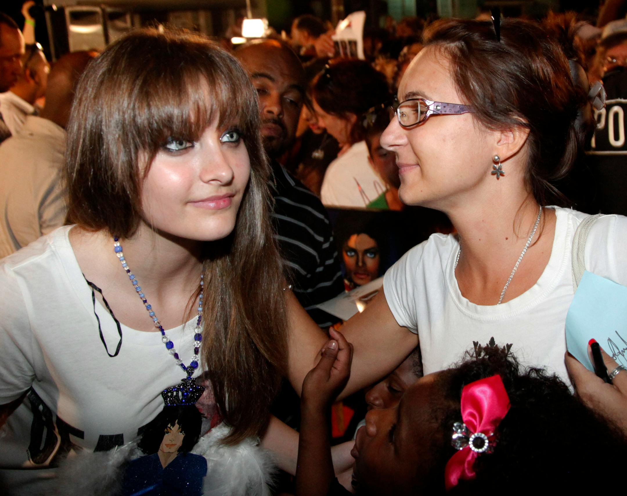 This Aug. 29, 2012 file photo shows Paris Jackson, left, daughter of the late pop icon Michael Jackson, poses with a fan outside Jackson's boyhood home during a celebration on what would have been Jackson's 54th birthday in Gary, Ind.
