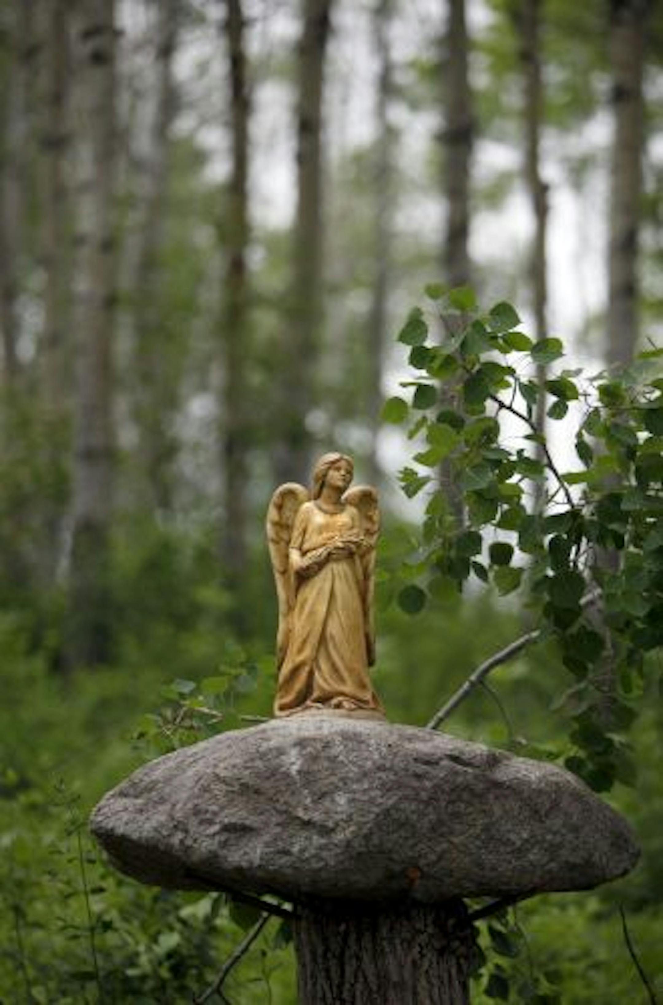 An angel is perched on a rock on the park land. Terry Tomann says the angel is "someone to look ater the park."