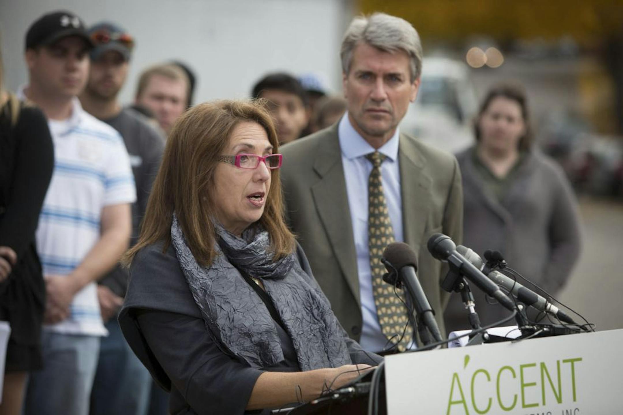 Shereen Rahamim, the wife of Accent Signage owner Reuven Rahamim, spoke Monday of her husband and five others killed in the Sept. 27 shooting: "Their loss has taken a tremendous toll on our company and had an unimaginable impact on our families." Minneapolis Mayor R.T. Rybak also spoke in support of Accent.