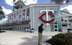 Twins fan Bill Gallegos, of Los Angeles, Calif., checks his phone after taking pictures outside a closed Hammond Stadium in March.