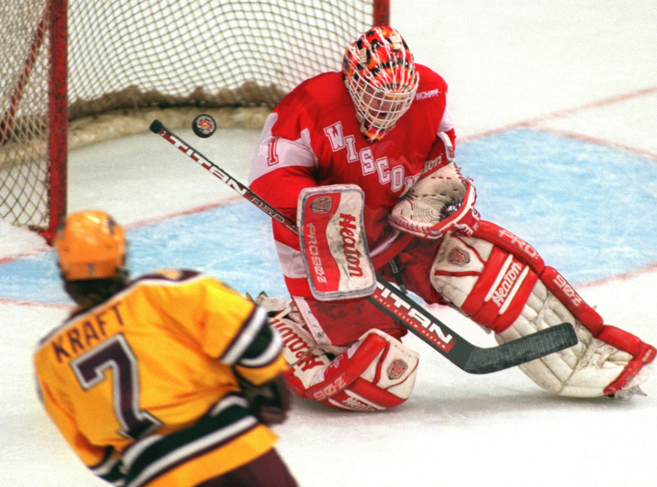 -- The Gophers Ryan Kraft scores a first period goal against Wiscon sin goalie Kirk Daubenspeck.