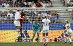 United States'Samantha Mewis, top left, jumps to defend as Spain's Patri Guijarro makes an attempt to score during the Women's World Cup round of 16 s