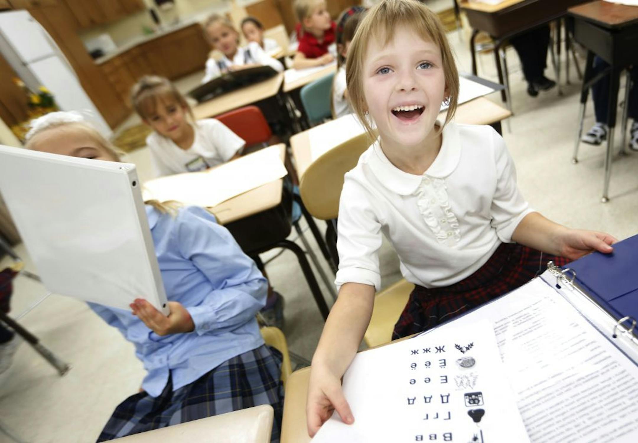 At the Nasha Shkola, the first Russian charter school in the midwest ,Liza Shliomina,7 , right, reviewed the spelling and pronunciation of the cyrillic alphabet during Russian language class .