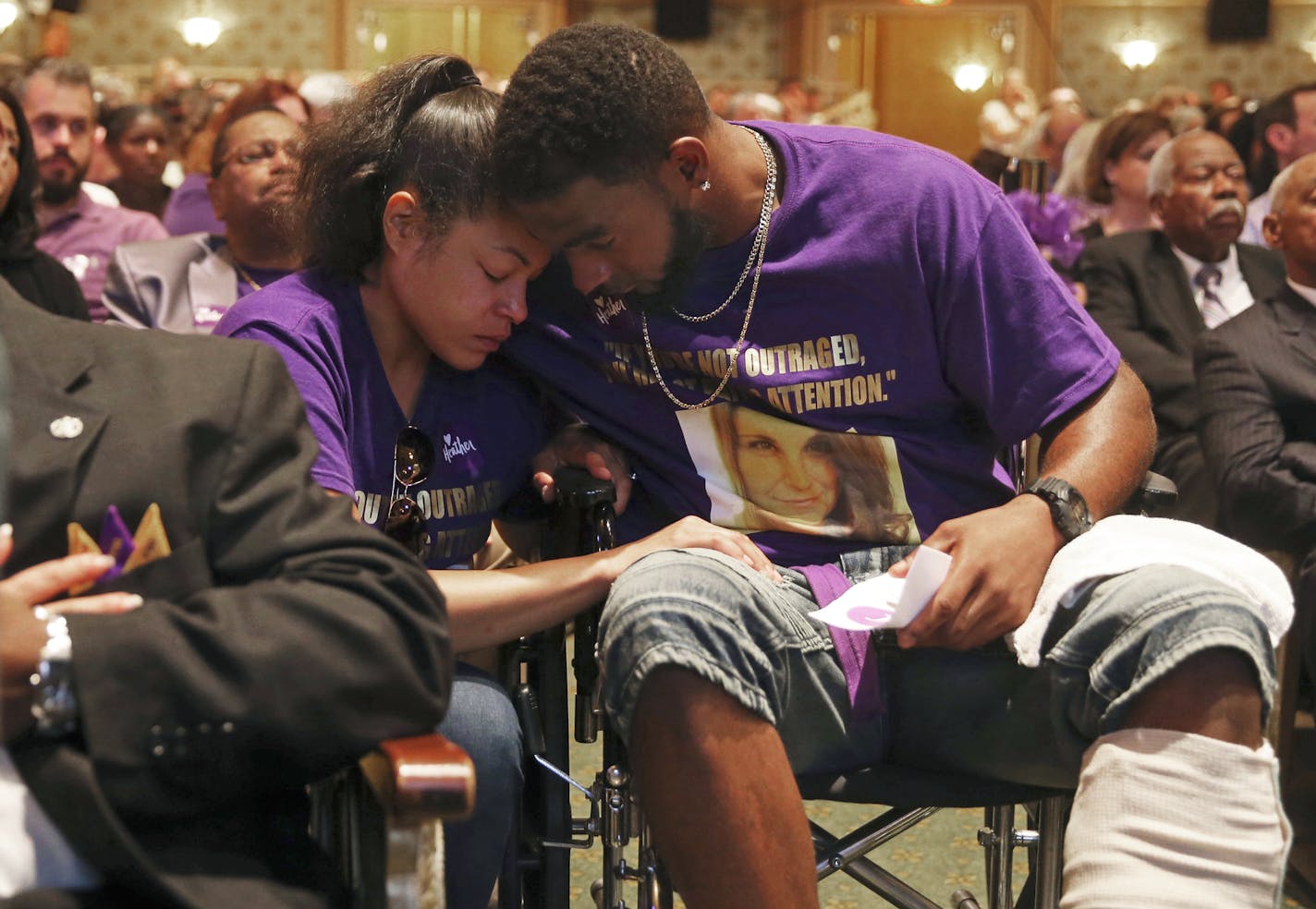 Marcus Martin, right, hugs his fiance Marissa Blair, left, during a memorial for Heather Heyer Wednesday, Aug. 16, 2017, at the Paramount Theater in Charlottesville, Va. Martin pushed his fiance out of the way of the vehicle that killed Heyer last Saturday. (Andrew Shurtleff/The Daily Progress via AP, Pool)