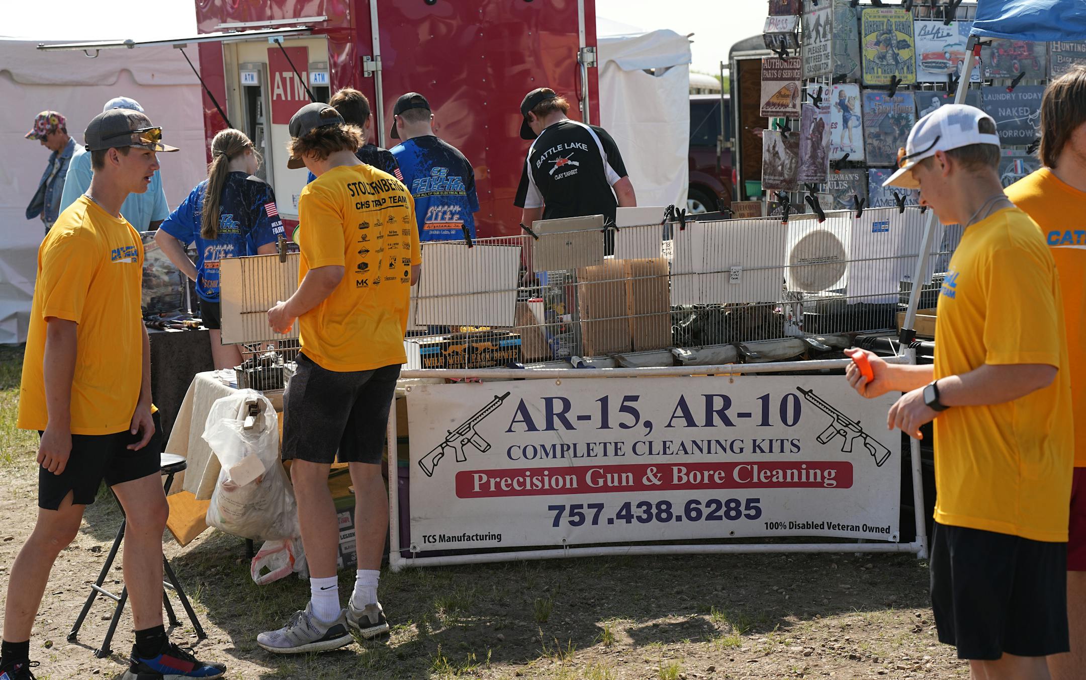 A booth at the Minnesota State High School Trap Shooting Championships advertises cleaning kits for guns.