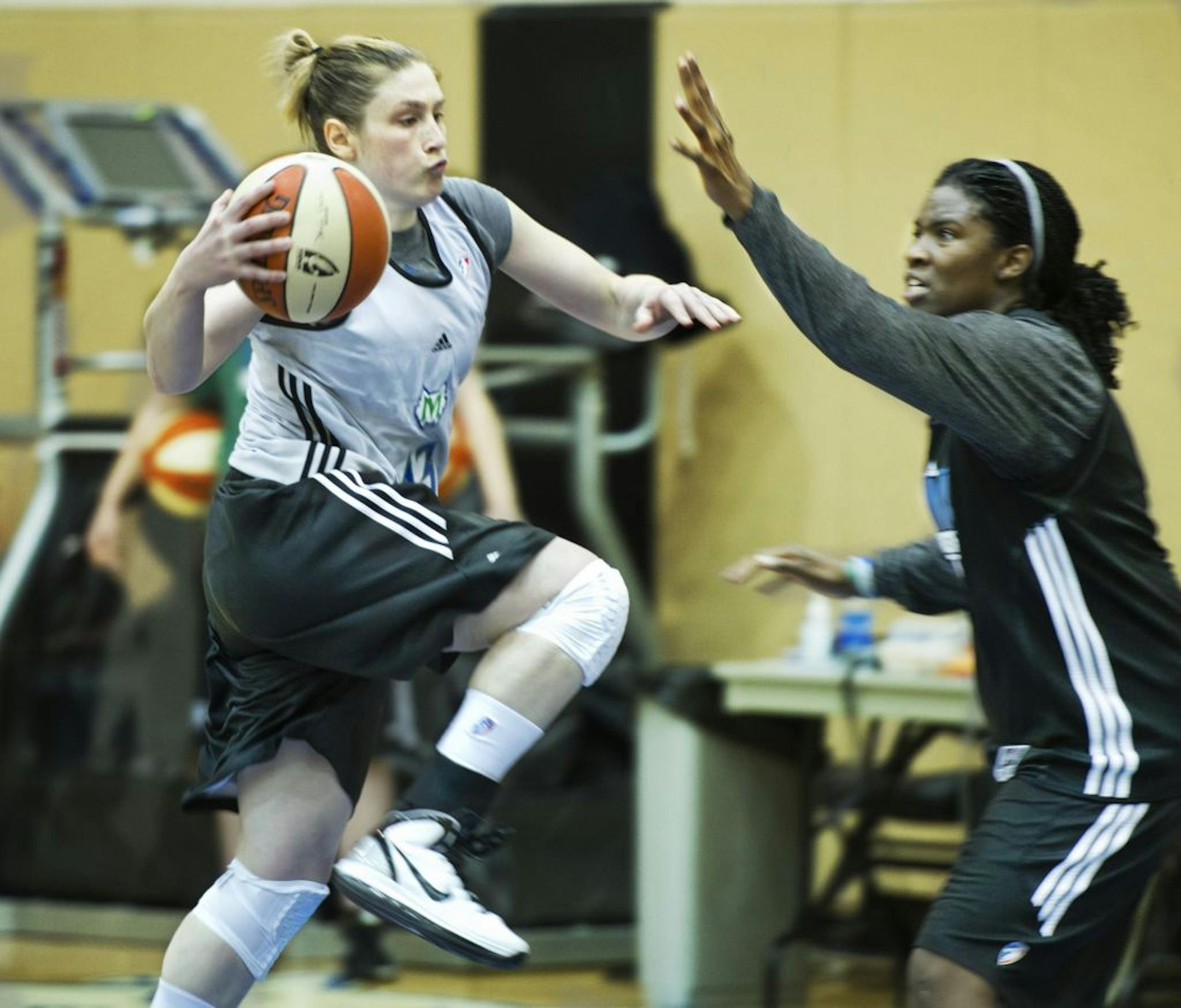 Lindsay Whalen drives past teammate Amber Harris during practice at the Target Life Time Fitness Center Sunday afternoon.
