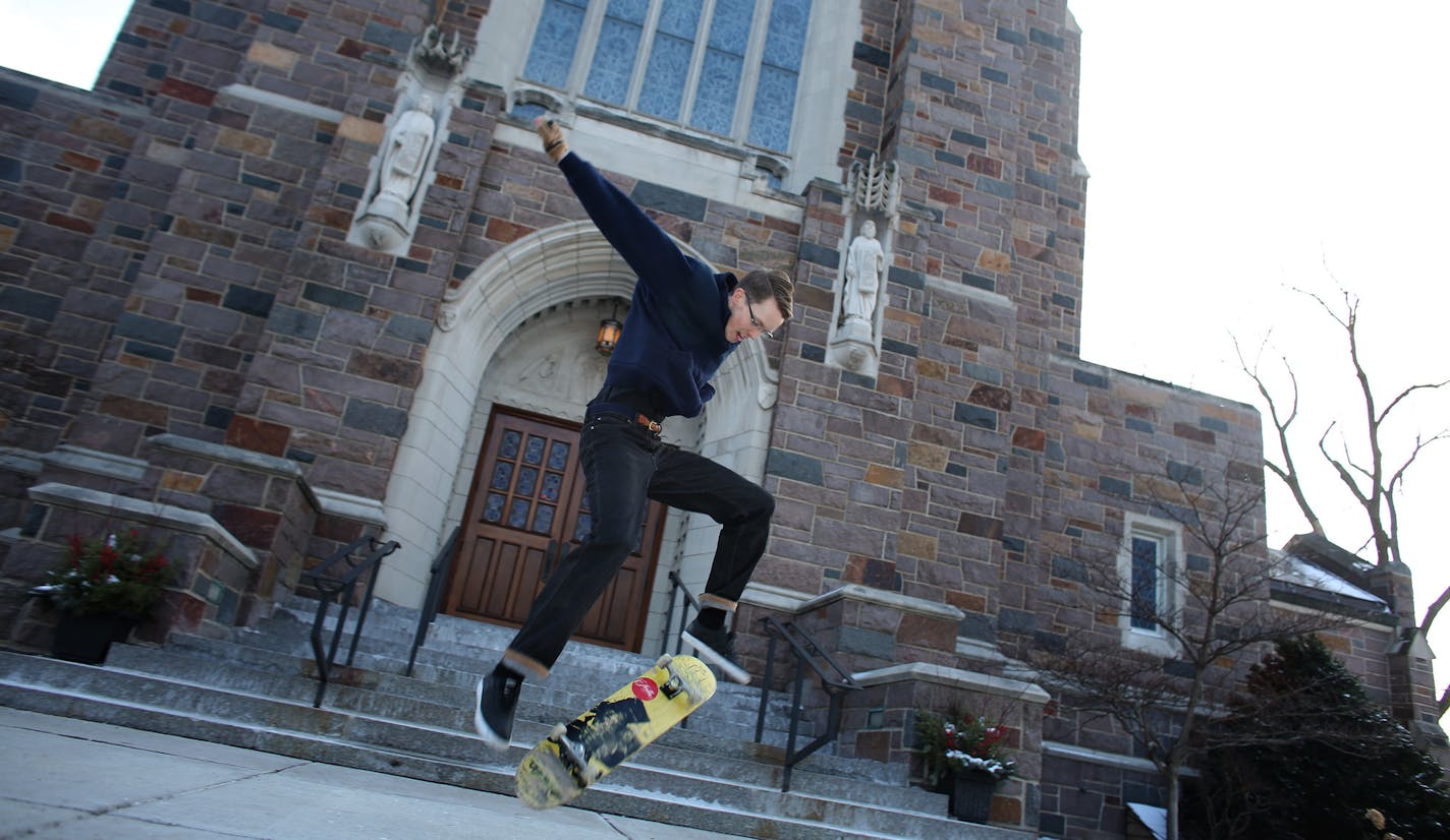 Fr. Andrew Brinkman, 29, demonstrated some skateboard tricks in front of the church he worked at. ] (KYNDELL HARKNESS/STAR TRIBUNE) kyndell.harkness@startribune.com At Nativity of Our Lord Church in St. PaulMin., Wednesday, December 17, 2014.