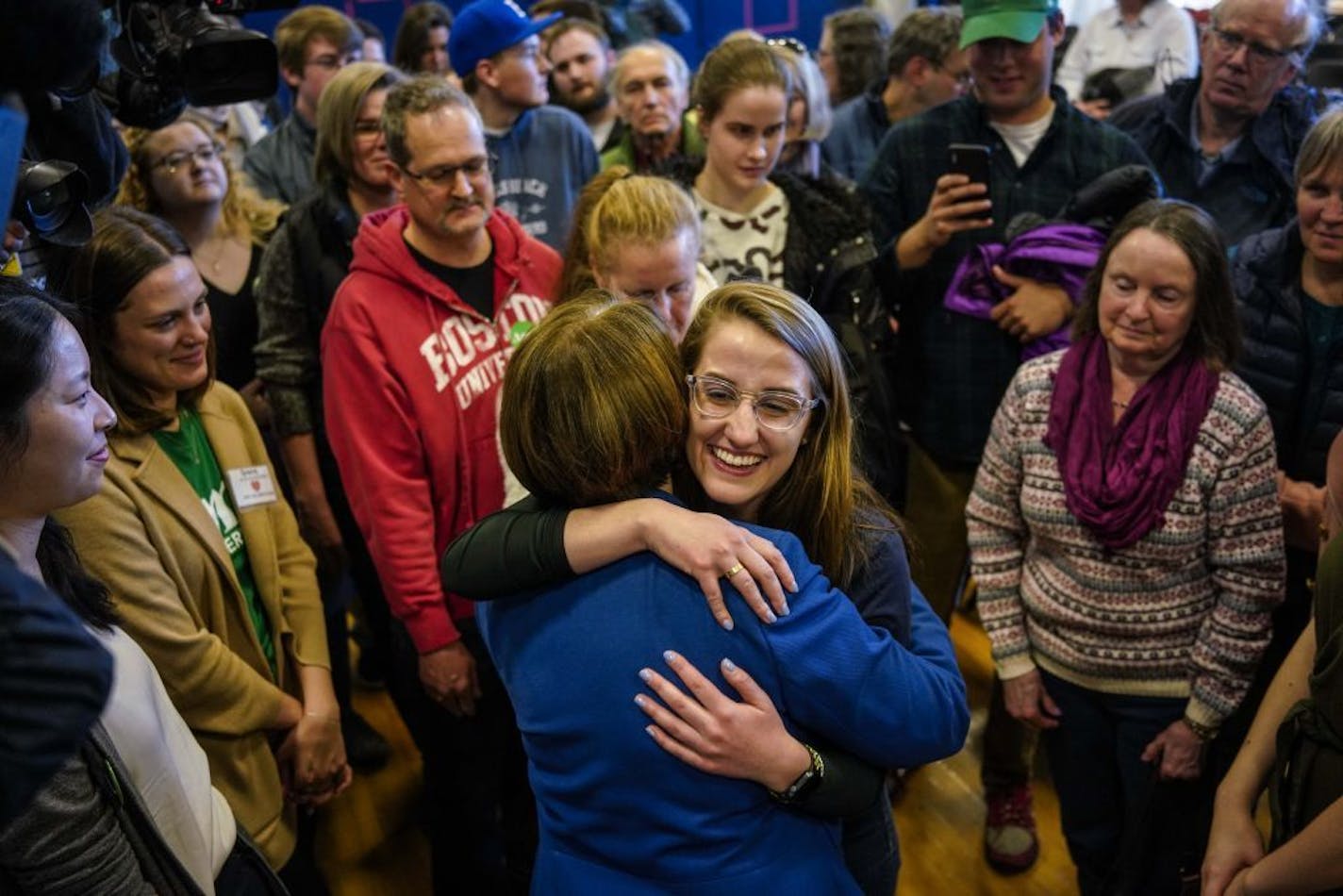 Jamie Engel of Boston gets a hug from Sen. Amy Klobuchar (D-Minn.) as she greets supporters after a town hall in Rye, N.H., March 23, 2019. At events across early primary states, voters asked about health care and school shootings and immigration.