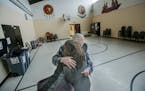 Allan Law, 73, who has helped the needy for more than 50 years, hugged a former student at the Little Earth gym.