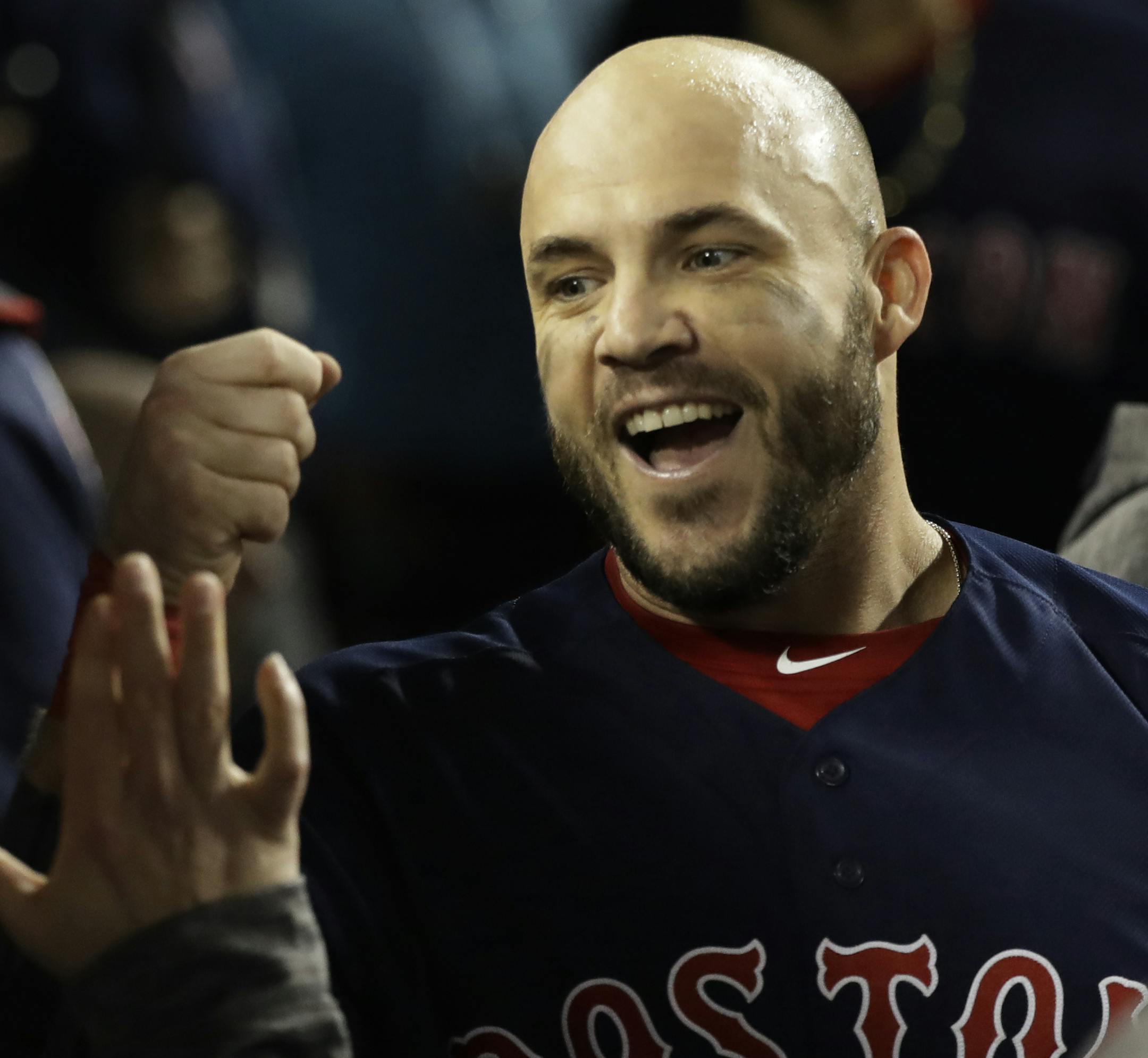 ]Boston Red Sox's Steve Pearce celebrates in the dugout after scoring on a single by Xander Bogaerts during the ninth inning in Game 4 of the World Series baseball game on Saturday, Oct. 27, 2018, in Los Angeles. Center is Los Angeles Dodgers catcher Austin Barnes. Pearce hit a three-run RBI double in the inning. (AP Photo/David J. Phillip)