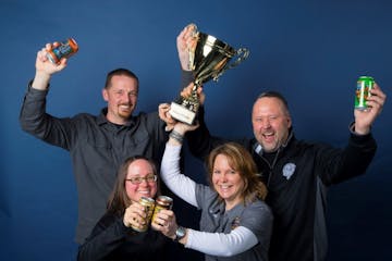 Castle Danger brewery owners (from left) Clint MacFarlane, Jamie MacFarlane, Mandy Larson and Lon Larson hoisted the trophy.