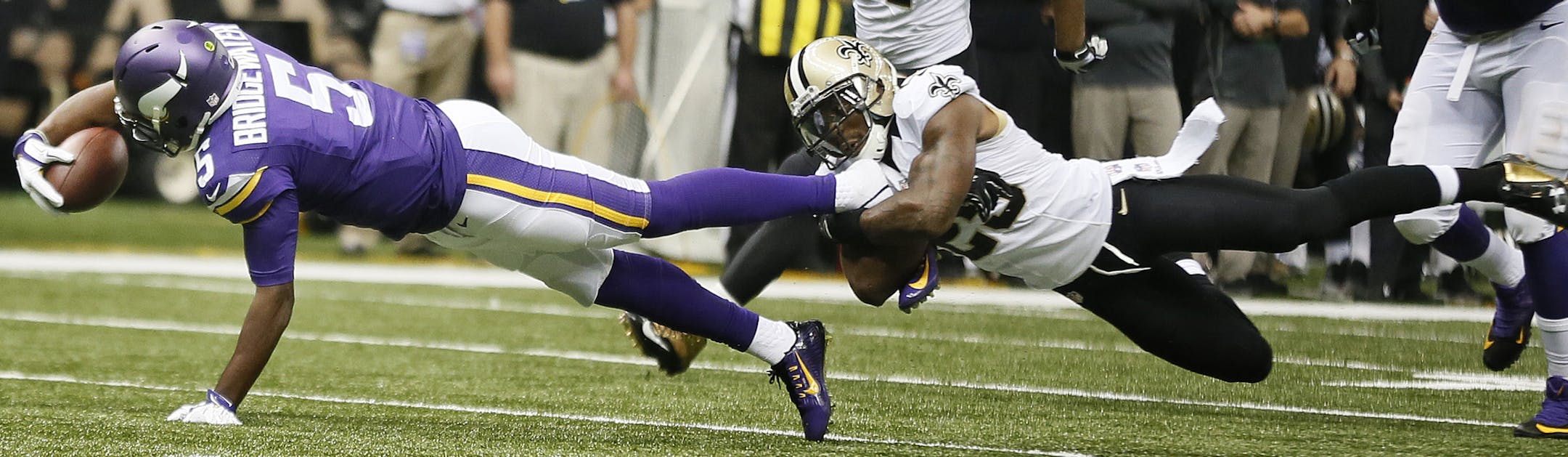 Minnesota Vikings quarterback Teddy Bridgewater (5) picked up a first down in the second quarter, as he was tackled by New Orleans Saints cornerback Keenan Lewis (28).The Minnesota Vikings played the New Orleans Saints at the Mercedes-Benz Superdome Sunday September 21 , 2014 in New Orleans ,LA. ] Jerry Holt Jerry.holt@startribune.com