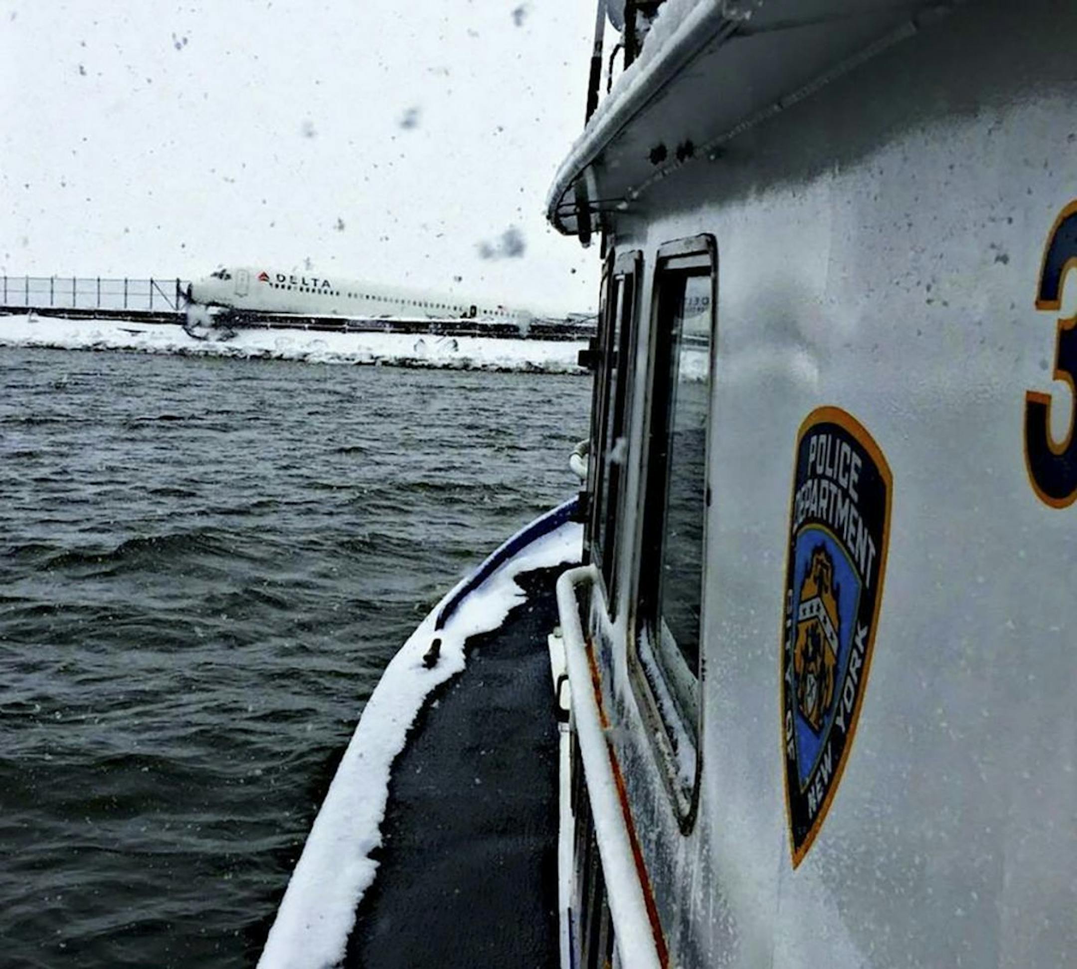 A handout photo taken from an NYPD harbor unit as it approaches the Delta Air Lines plane that skidded off the runway and came to rest on an embankment just short of Flushing Bay at LaGuardia airport in New York, March 5, 2015. Officials reported no serious injuries among the 127 passengers and five crew arriving from Atlanta during a snowstorm, but scores of other flights were canceled. (New York Police Department via The New York Times) -- FOR EDITORIAL USE ONLY