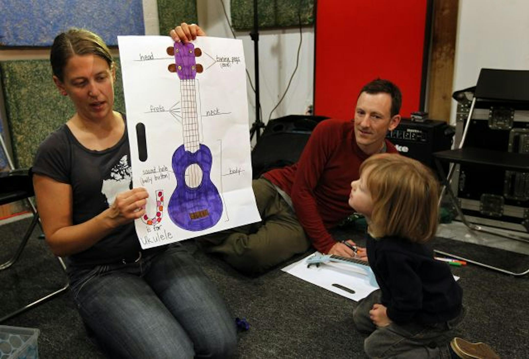 Instructor Brianna Lane held up a drawing of a ukulele as Silas Holtan, 3, and his dad, John Holtan, listened during a class at Twin Town Guitars in Minneapolis.