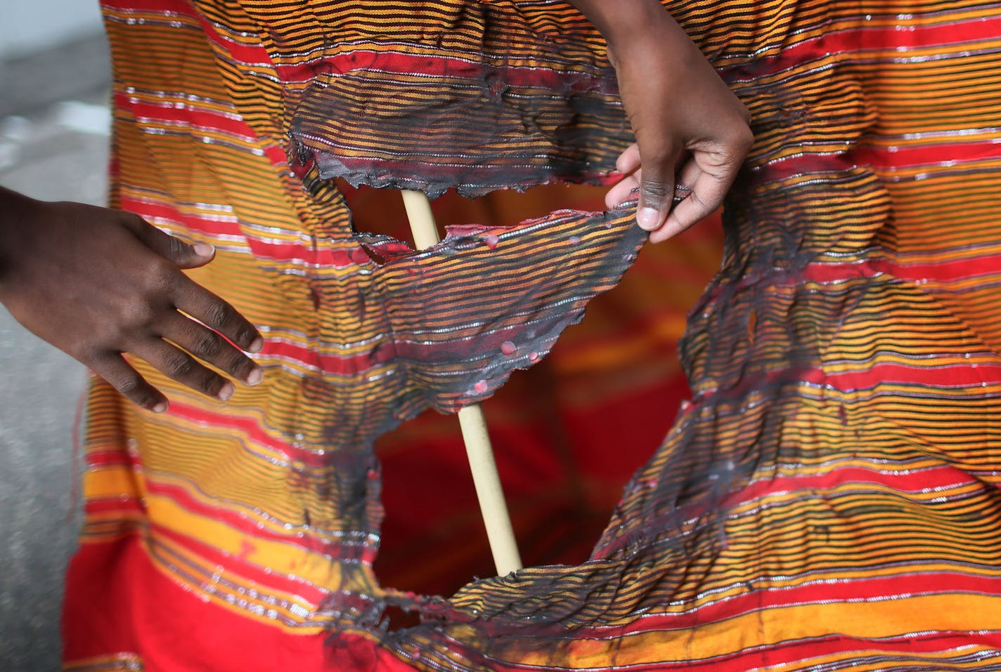 Mansour burned a hole in the dress of her &#x201c;grandma&#x201d; puppet to symbolize the hardship her grandma has endured.