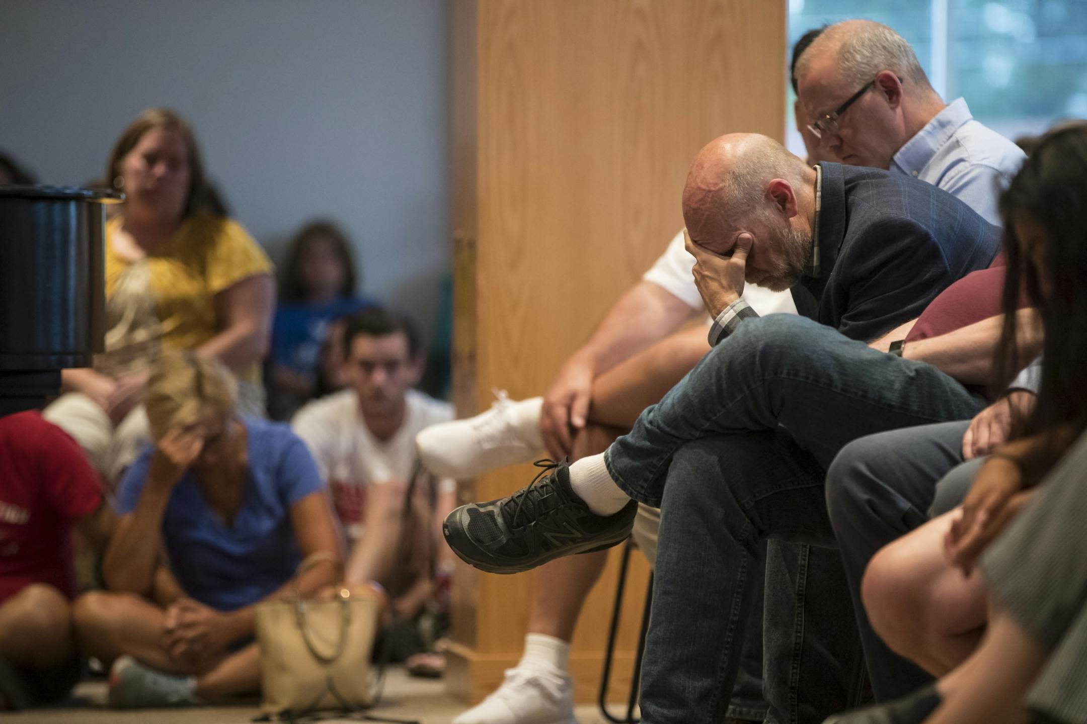 People who attended prayed during a prayer service at the Minnehaha Academy Lower School in the evening after an explosion in the Upper campus that morning on August 2, 2017 in Minneapolis, Minn.