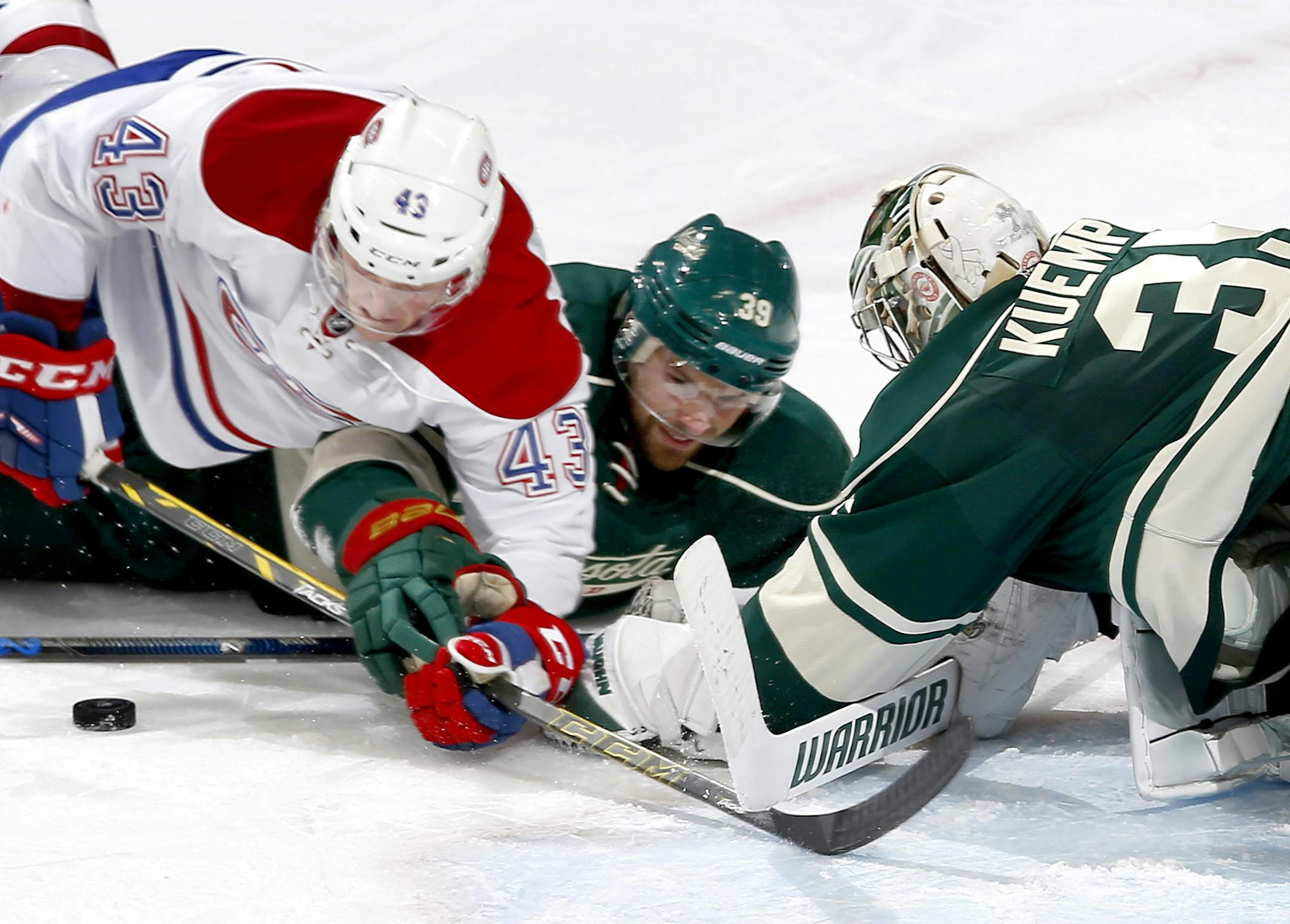 Montreal’s Daniel Carr, left, dived for the puck as Wild defenseman Nate Prosser and goalie Darcy Kuemper defended. Kuemper made 24 saves in the Wild's 2-1 victory.