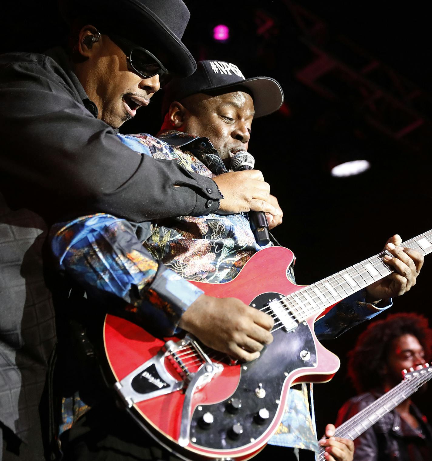 Tony Mosley holds the microphone for guitar player Levi Seacer Jr. during the New Power Generation show. ] LEILA NAVIDI • leila.navidi@startribune.com BACKGROUND INFORMATION: The New Power Generation plays a show at First Avenue in Minneapolis on Thursday, September 13, 2018.