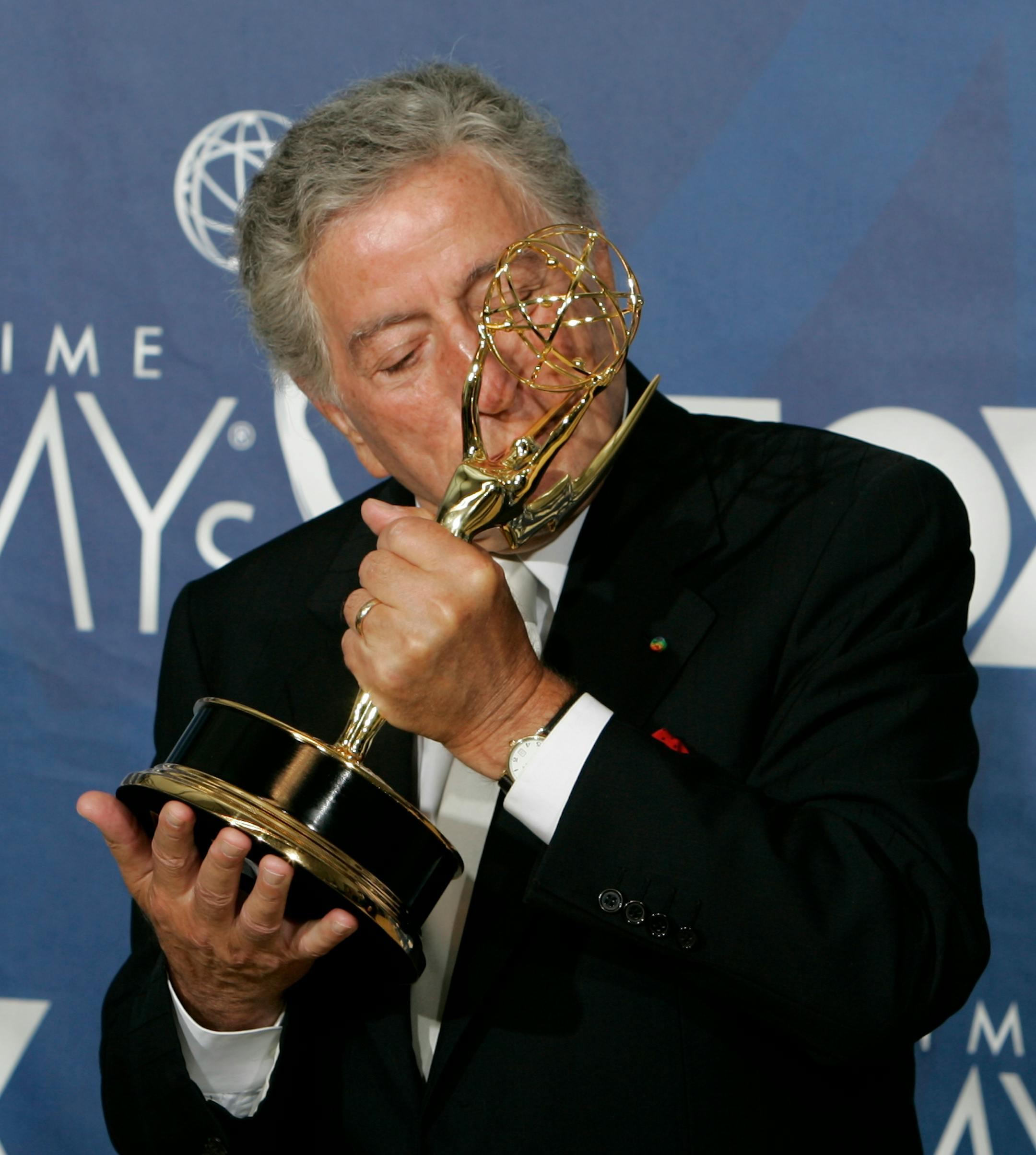 Singer Tony Bennett kisses the award for outstanding individual performance in a variety of music programs for his work on the "Tony Bennett: An American Classic" at the 59th Primetime Emmy Awards Sunday, Sept. 16, 2007, in Los Angeles.