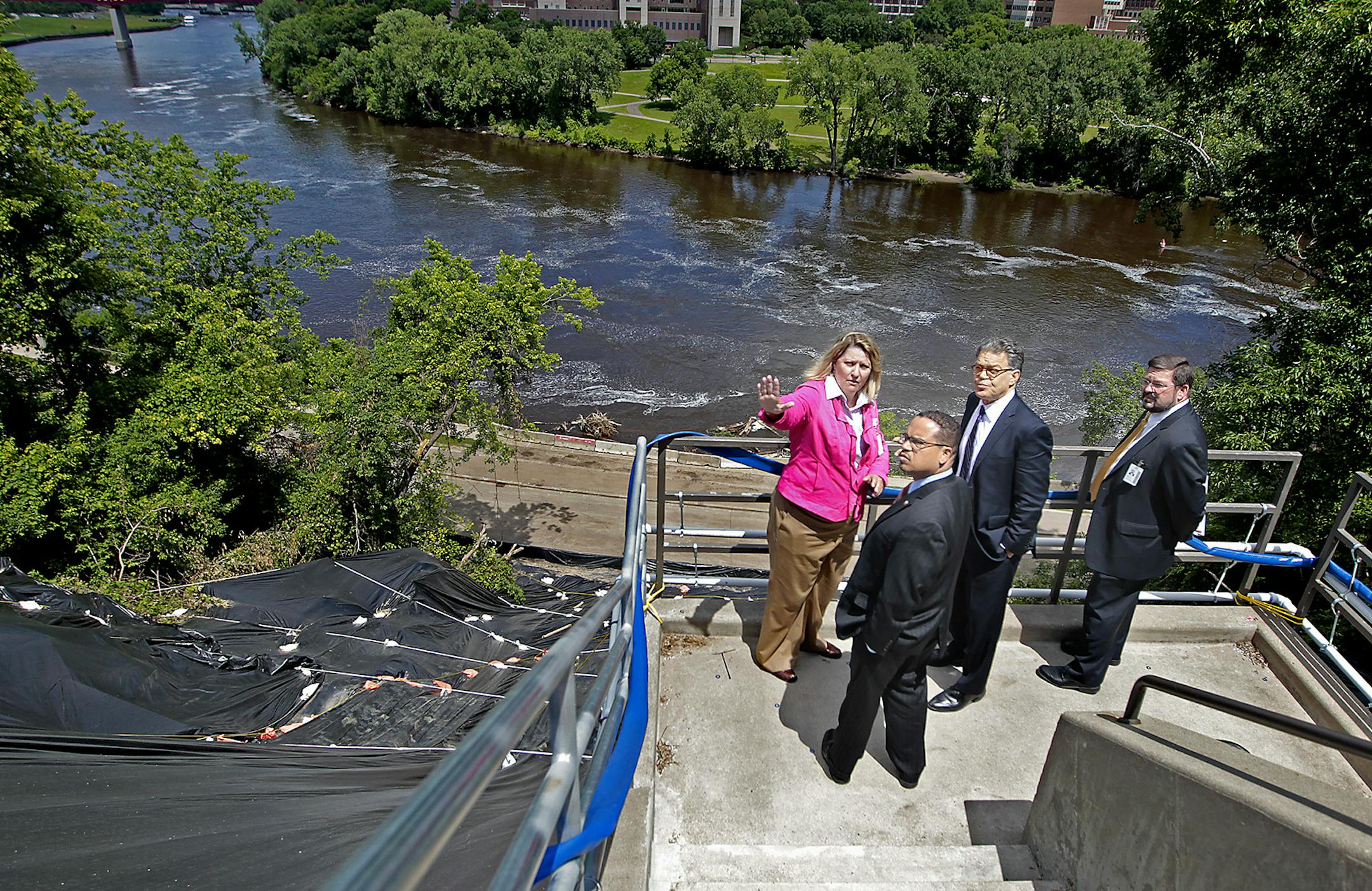 Fairview Health Services Vice President of Public Policy Mary Edwards, left, and Paul Onufer, right, in charge of operations at the University of Minnesota Medical Center, gave Sen. Al Franken and Rep. Keith Ellison a tour Thursday of the damage at the Minneapolis hospital from a June 19 mudslide.
