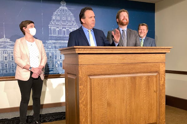 Republican State Rep. Pat Garofalo, of Farmington, second from left, and Democratic Rep. Zack Stephenson, of Coon Rapids, second from right, discuss t