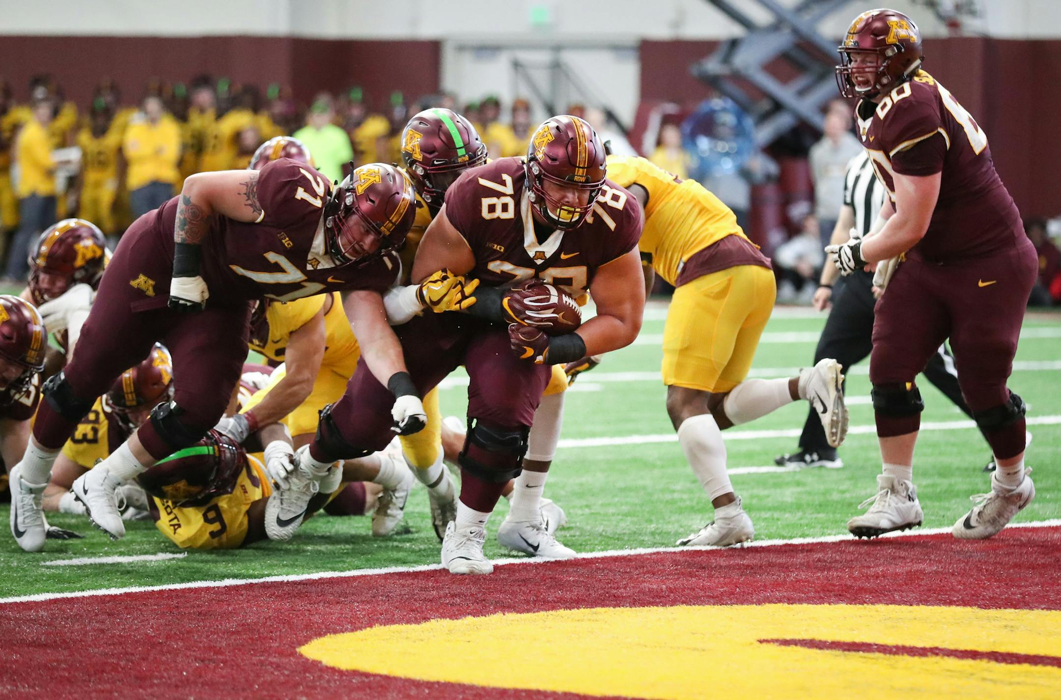 6-9 foot, 400-pound Daniel Faalele (78) rumbled into the endzone for a Gopher maroon touchdown in the second quarter. ] Shari L. Gross • shari.gross@startribune.com The Gopher maroon team came out on top of the gold team in the spring football game held inside the Athletes Village on the campus of the University of Minnesota, Saturday, April 13, 2019. GOPHERS SPRING FOOTBALL GAME.