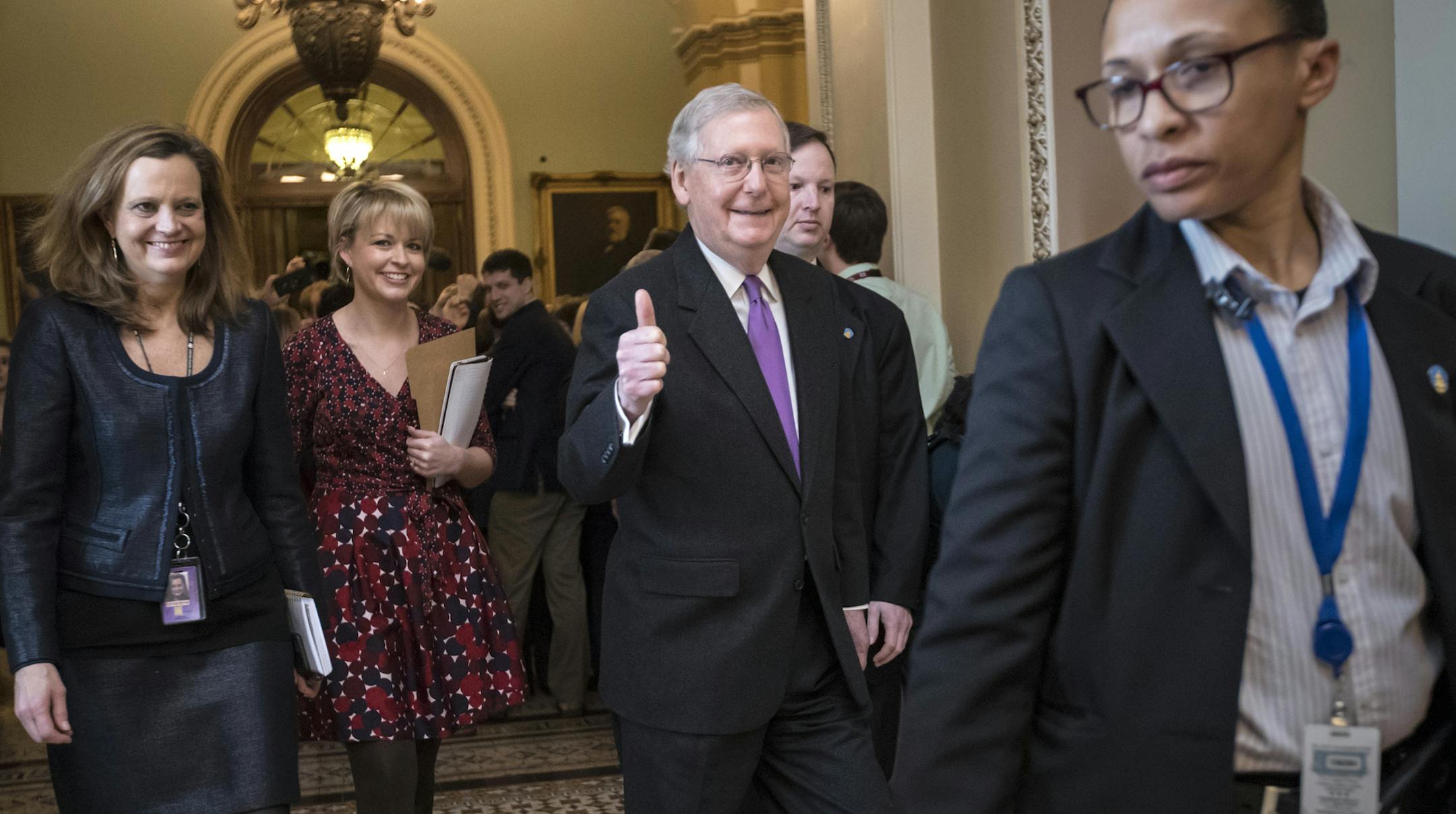 Senate Majority Leader Mitch McConnell, R-Ky., signals a thumbs-up after a vote to reopen the government passed at the Capitol in Washington, Monday, Jan. 22, 2018. (AP Photo/J. Scott Applewhite)