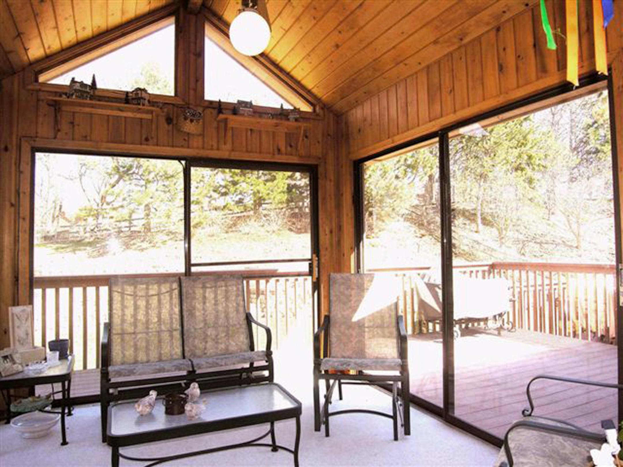 The sun porch had a bland furniture arrangement and lack of color.