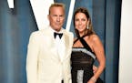 Kevin Costner, left, and Christine Baumgartner arrived at the Vanity Fair Oscar Party, March 27, 2022, in Beverly Hills, Calif. A judge has declared t