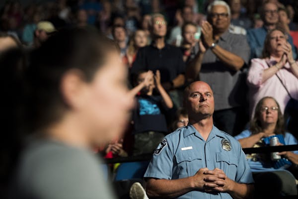 Minneapolis police officer Michael Osbeck looked towards the court as the Lynx's starting lineup is announced.